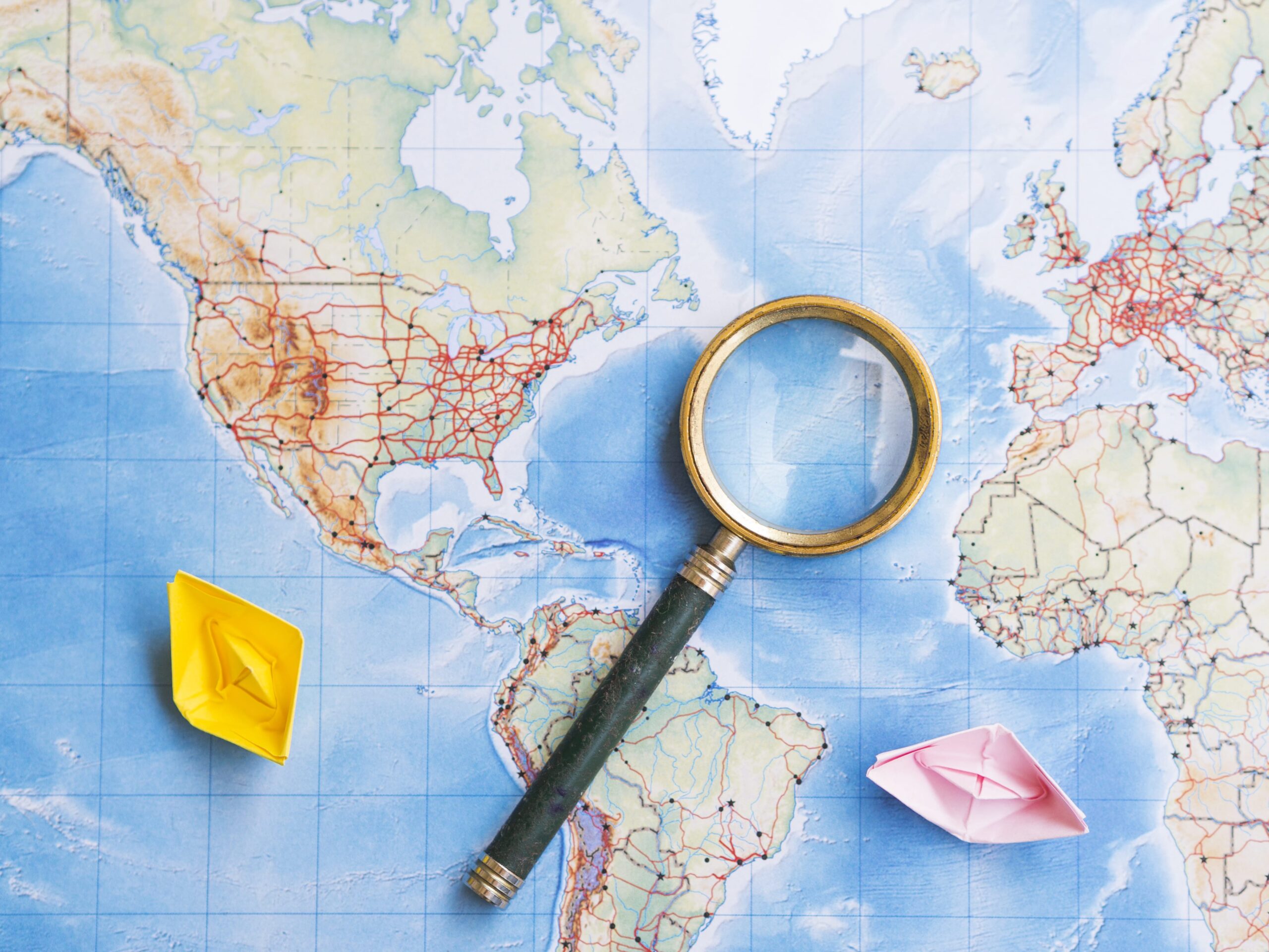 magnifying-glass-world-map-min
